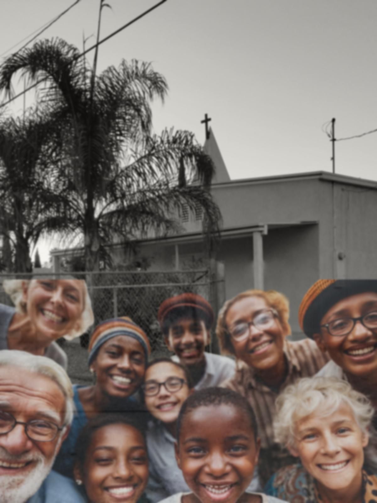 A gathered congregation smiling together in front of the church
